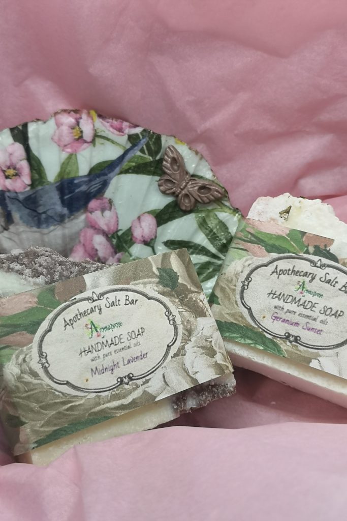 Handmade soaps sitting on a decoupage soap dish
