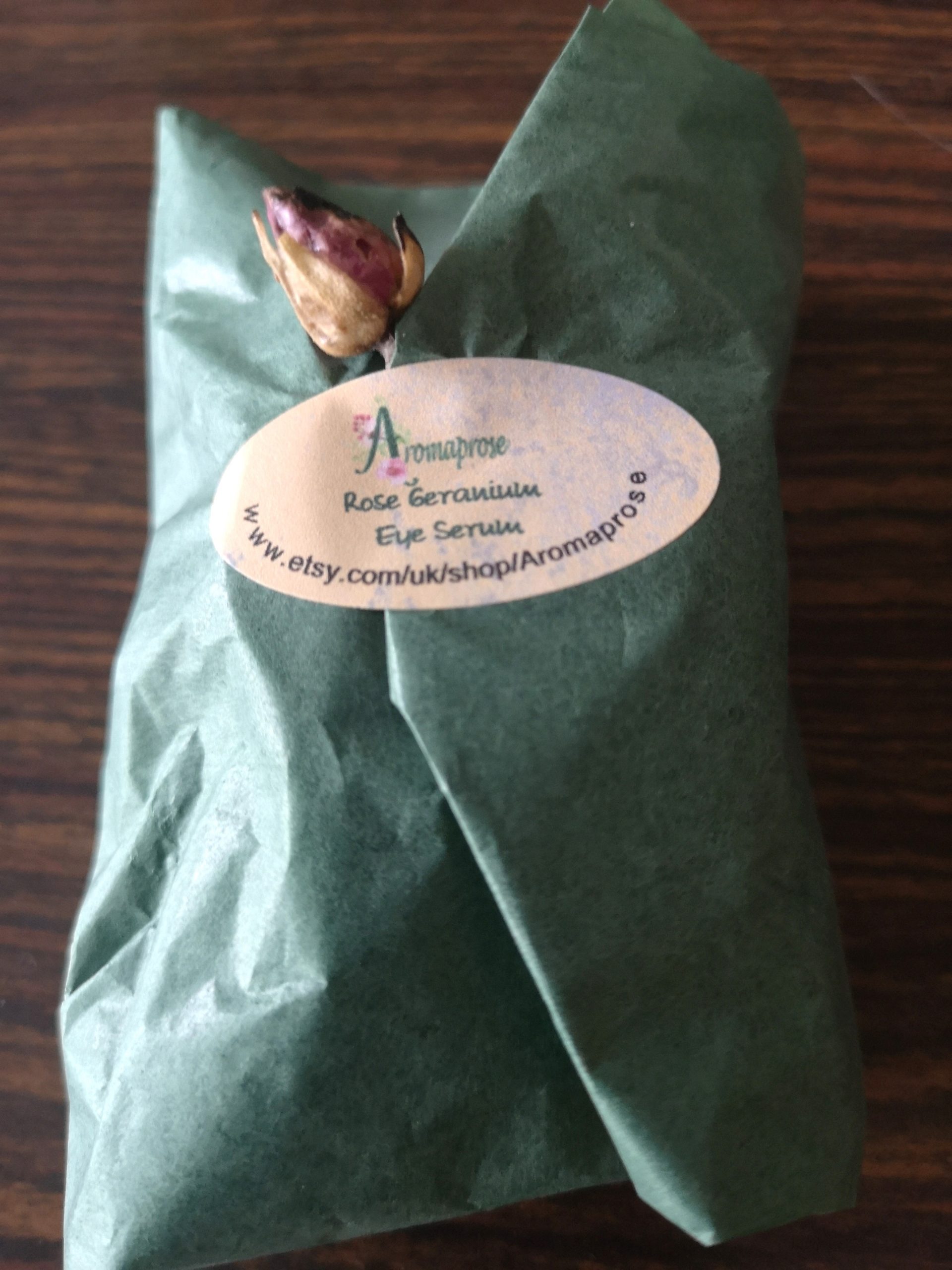 Green tissue paper packaging for Eye Balm with dried flower embellishment