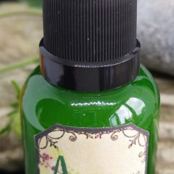 Pillow and Aura spray in a green bottle