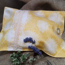a yellow and white herbal pillow