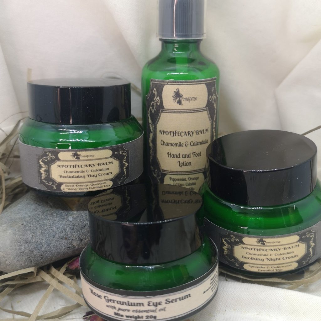 A set of handmade Apothecary Balms in green glass jars or bottles