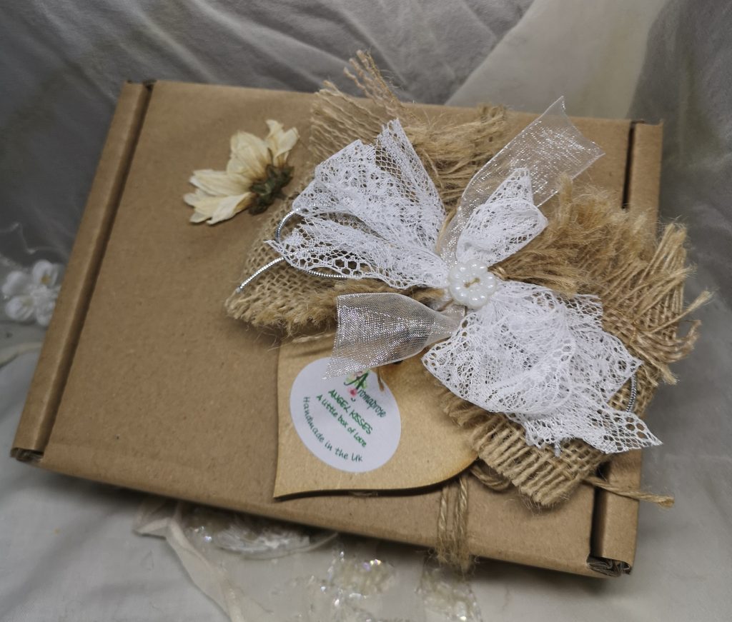 An eco kraft gift box decorated with ribbon and lace