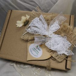 An eco kraft gift box decorated with ribbon and lace