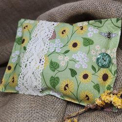 a pretty green and yellow herbal pillow with sunflowers and bee detail