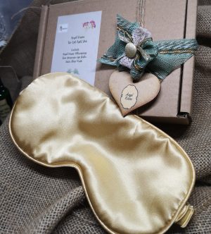 A gold coloured satin eye mask