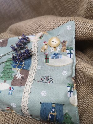 Green Christmas fabric herbal pillow showing button detail