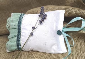 White herbal pillow with green Christmas ribbon