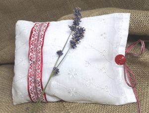 a white herbal pillow with red Christmas detail