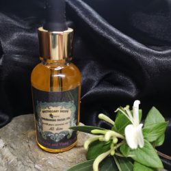 A golden facial oil in dropper bottle