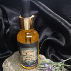 A golden facial oil in a dropper bottle
